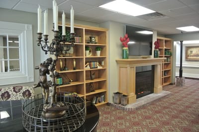 Cozy common area with a fireplace and bookshelves