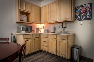 Well-lit kitchen area with cabinetry and appliances.