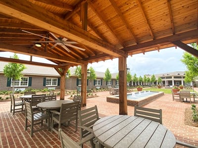 Outdoor seating area with a fountain and landscaped garden