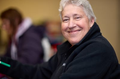 Smiling resident in a warm indoor setting