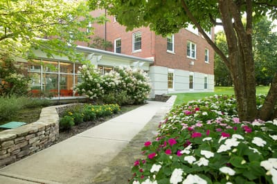 Pathway leading to the facility entrance with flowers