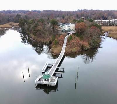Aerial view of a facility on an island with boardwalk.