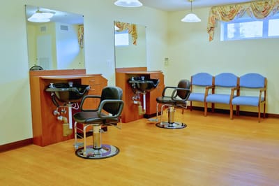 Interior view of a salon area with styling chairs and mirrors