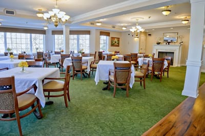 Dining area with tables set for residents