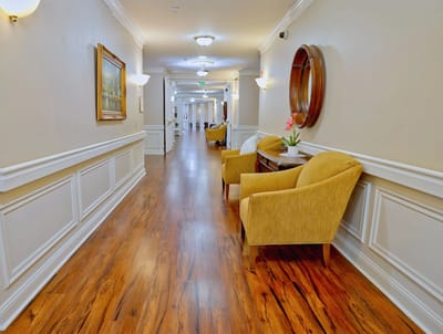 Bright interior hallway with seating area and artwork