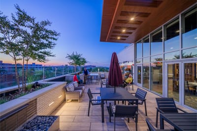 Outdoor terrace with seating and sunset view