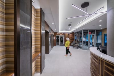 A well-lit lobby area with a resident walking