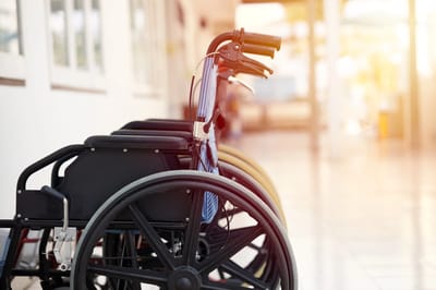 Wheelchairs lined up in a bright hallway