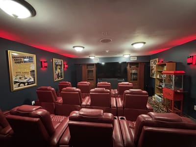 Interior of a comfortable theater room with red seating