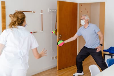Resident engaging in physical therapy with staff member