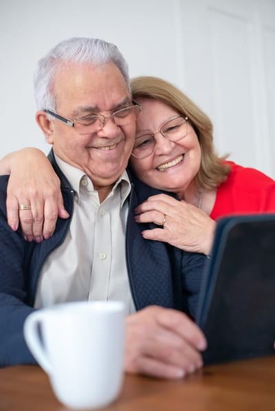 Elderly couple enjoying time together with a tablet