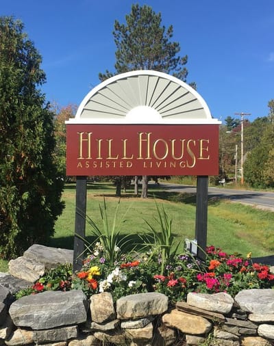 Signage for Hillhouse Assisted Living with flower beds