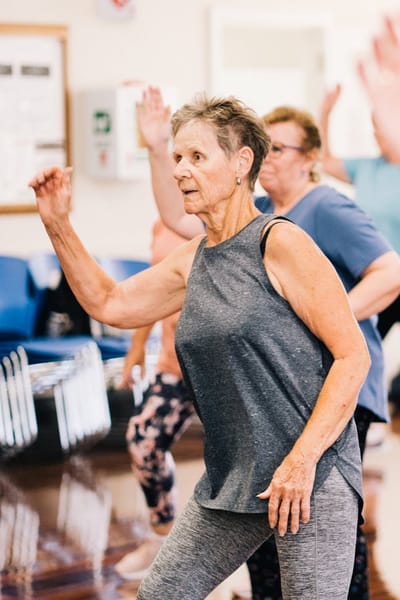 Residents participating in an exercise class indoors