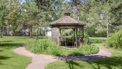 Gazebo surrounded by greenery in a landscaped garden