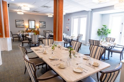 Dining room set for a meal with elegant table settings