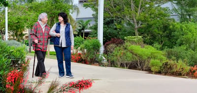 Arden Courts (cherry Hill), assisted living in Cherry Hill, NJ — Couple walking along a path in a landscaped garden