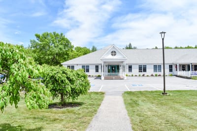 Exterior view of Bella Point Bridgton facility with greenery