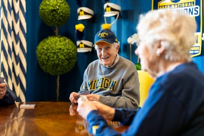 Residents engaged in a card game at a common area