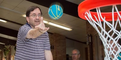 Residents playing basketball in an activity area