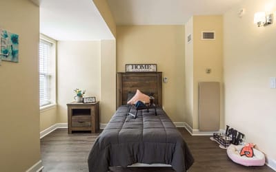 Private room with a bed and nightstand