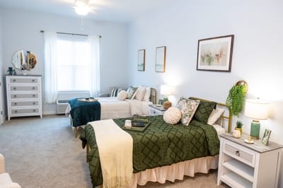 Brightly decorated resident room with two beds