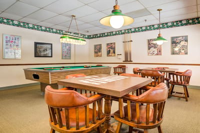 Interior game room with pool table and seating
