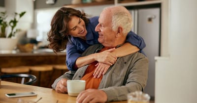 A caregiver interacting warmly with a resident in a communal space
