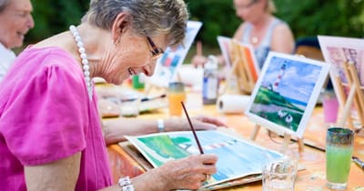 Residents participating in an outdoor painting activity