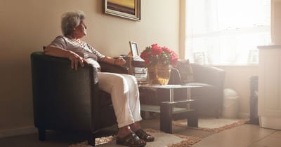 Senior resident sitting in a cozy indoor space