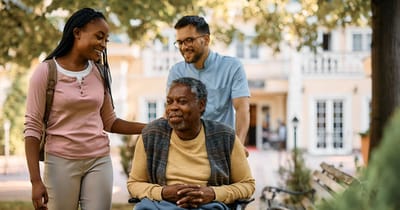 Residents enjoying time outdoors with staff in a garden area
