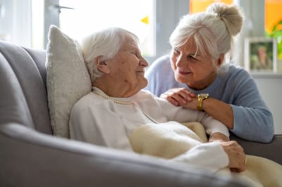 A caregiver and resident sharing a moment in a cozy setting