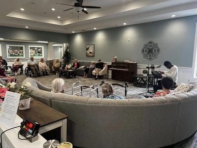 Residents enjoying a musical performance in a common area