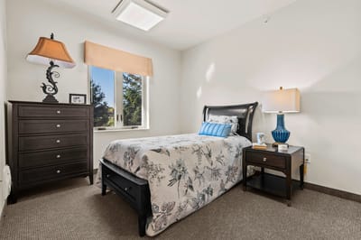 Cozy bedroom interior with a floral bedspread
