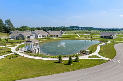 Aerial view of a serene assisted living community with a pond