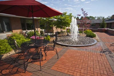 Outdoor patio with fountain and seating area