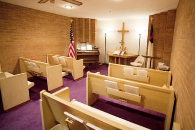 Interior view of a small chapel with pews