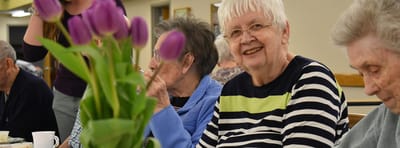Residents enjoying a social gathering with flowers