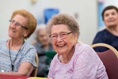 Resident laughing during a facility activity