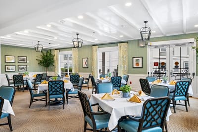Bright dining room with tables and chairs set for meals