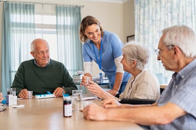 Residents engaged in an activity with staff in a common area