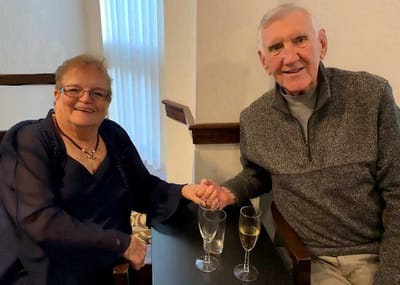 Two residents enjoying drinks together in a cozy setting