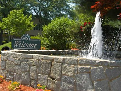 Welcoming landscaped area with a fountain