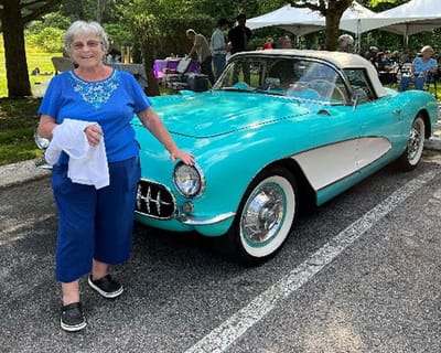 Resident enjoying a car event with a classic vehicle