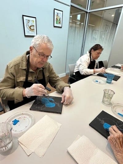 Residents engaged in a painting activity.