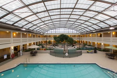 Indoor pool area with seating and greenery