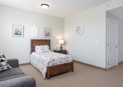 Bright private room with a bed and seating area