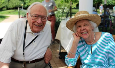 Two residents enjoying time outdoors in a garden setting