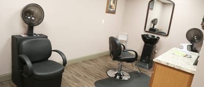 Hair salon area with styling chairs and equipment