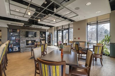 Cozy common area with chairs and bookshelves