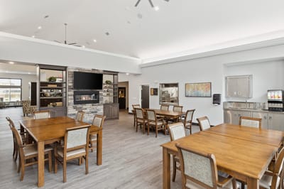 Bright dining area with tables and a fireplace